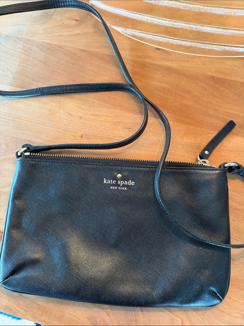 kate spade black leather crossbody wristlet with gold logo